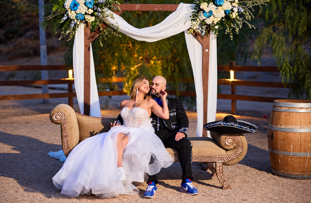 Newlyweds beneath a glowing floral arch